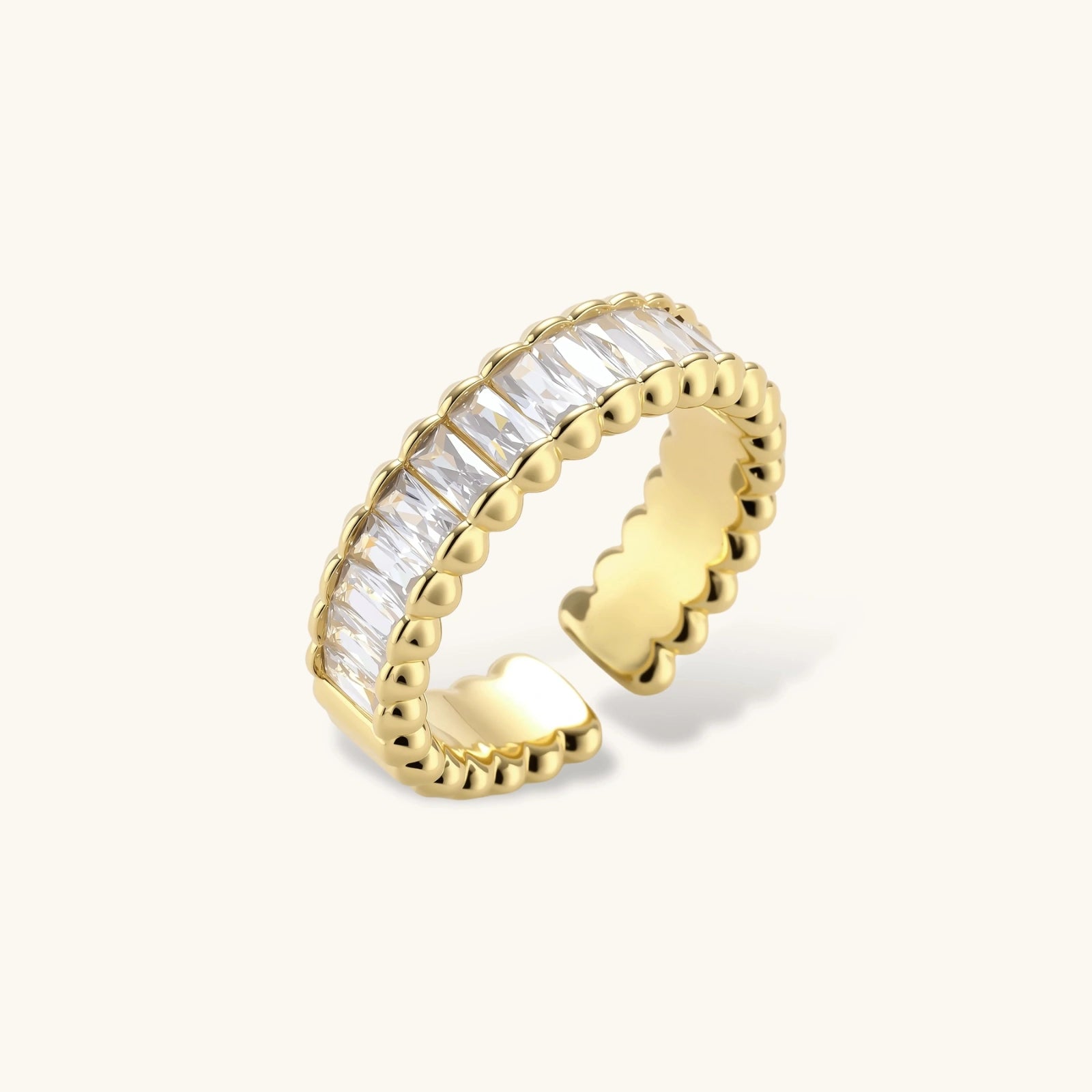 Adjustable gold-plated ring with rectangular cubic zirconia stones in eternity band style on neutral background.
